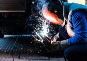 skilled mechanic welding some custom parts of his car.